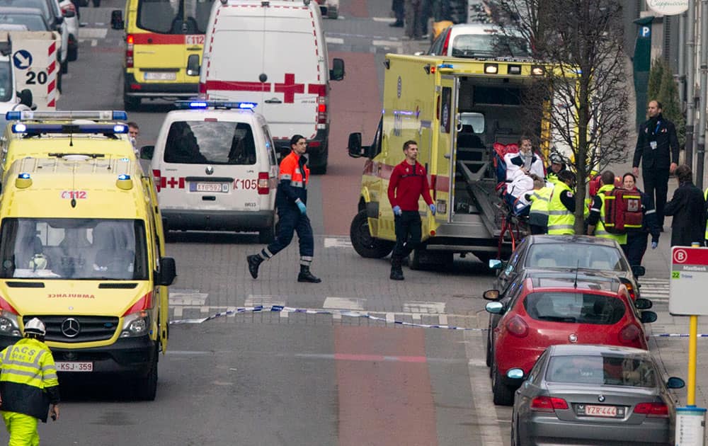 A woman is evacuated in an ambulance by emergency services after a explosion in a main metro station in Brussels.