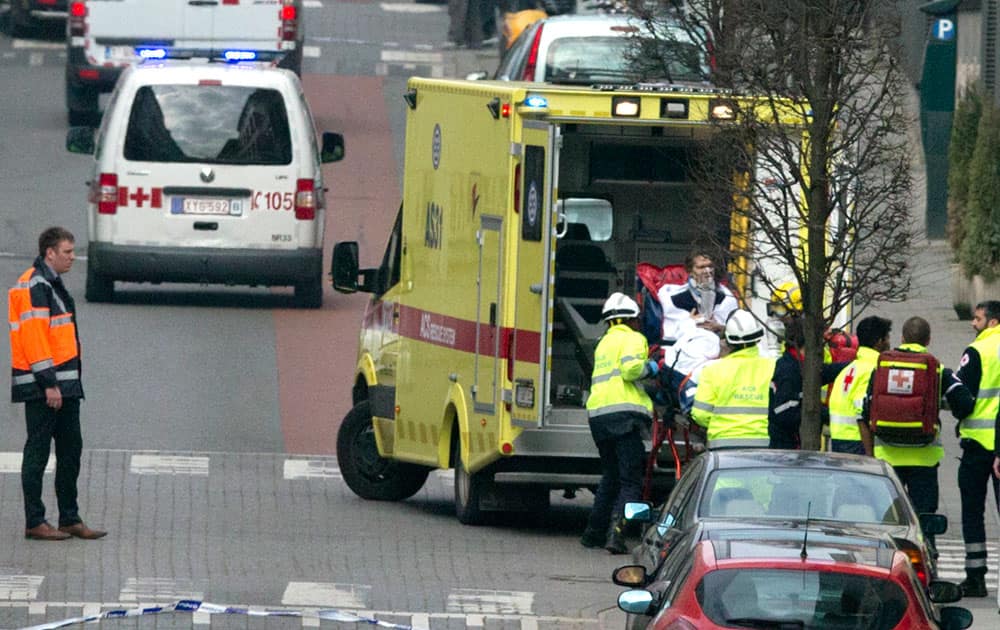 A woman is evacuated in an ambulance by emergency services after a explosion in a main metro station in Brussels.