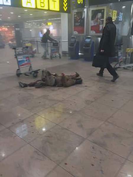 In this photo provided by Georgian Public Broadcaster and photographed by Ketevan Kardava a man is wounded in Brussels Airport in Brussels, Belgium, after explosions were heard.