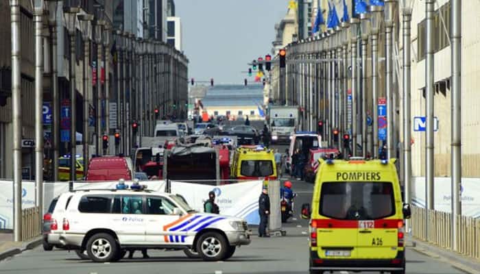 EU expresses solidarity with Brussels after deadly bombings; security tightened at airports, train stations 