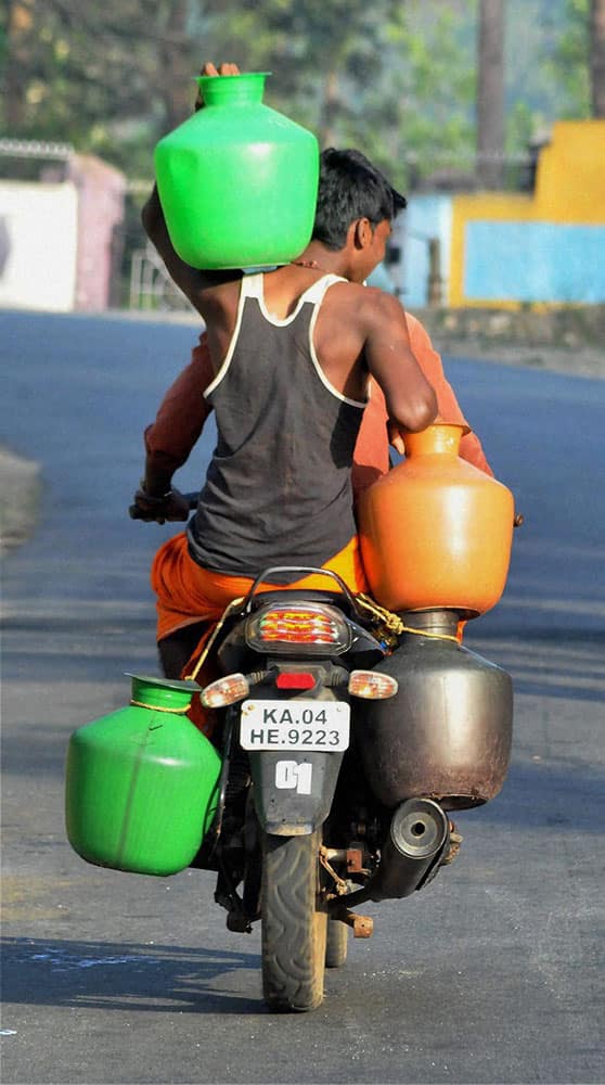 A villager carrying drinking water in pots in Chikmagalur in Karnataka.