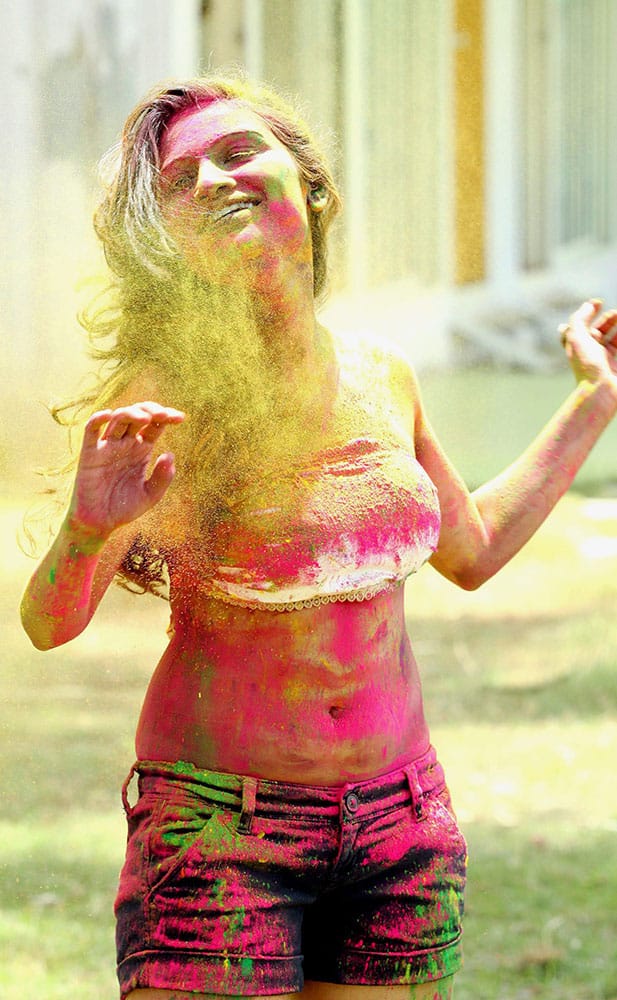 Bollywood and Marathi films actress Kesariee is daubed in colors while celebrating Holi in Mumbai.