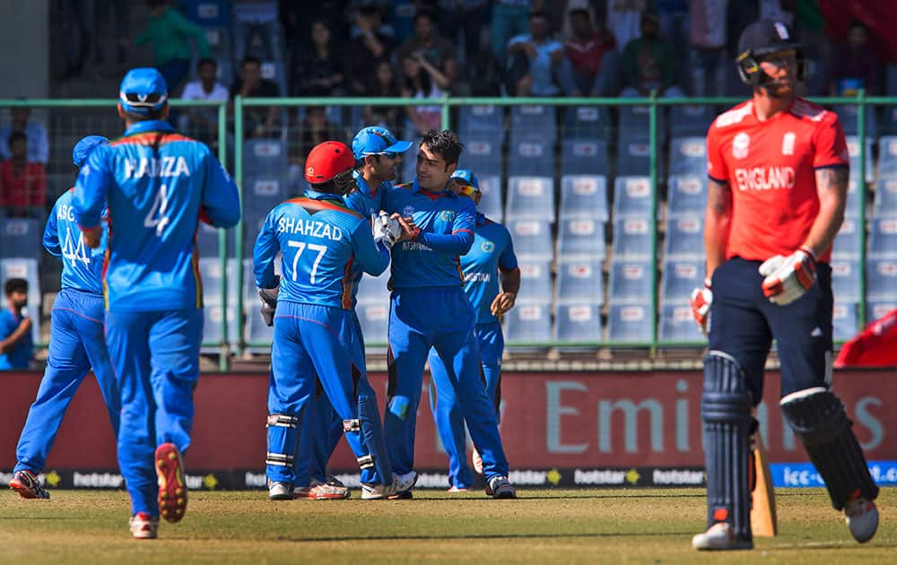 Afghanistan’s Rashid Khan celebrates with team mates after claiming the wicket of England's Ben Stokes during their ICC Twenty20 2016 Cricket World Cup match at the Feroz Shah Kotla cricket stadium in New Delhi.