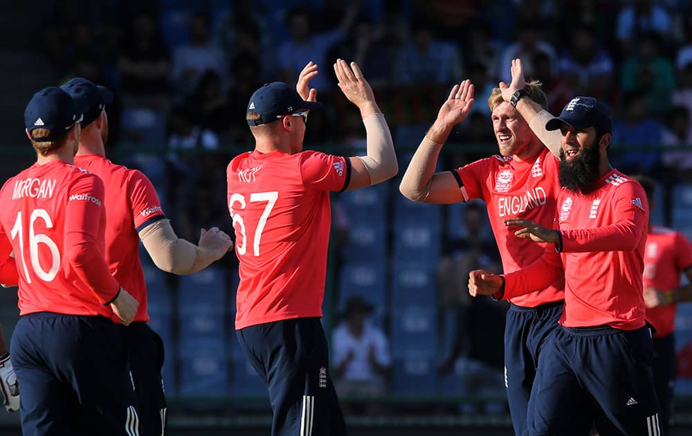 England's David Willey celebrates with team mates after claiming a wicket against Afghanistan during their ICC Twenty20 2016 Cricket World Cup match at the Feroz Shah Kotla cricket stadium in New Delhi.