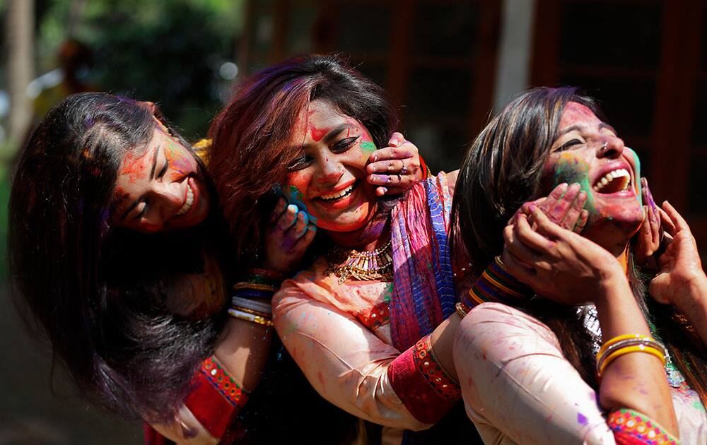 Bangladeshi Indian girls celebrate Holi with color powder in Dhaka, Bangladesh.
