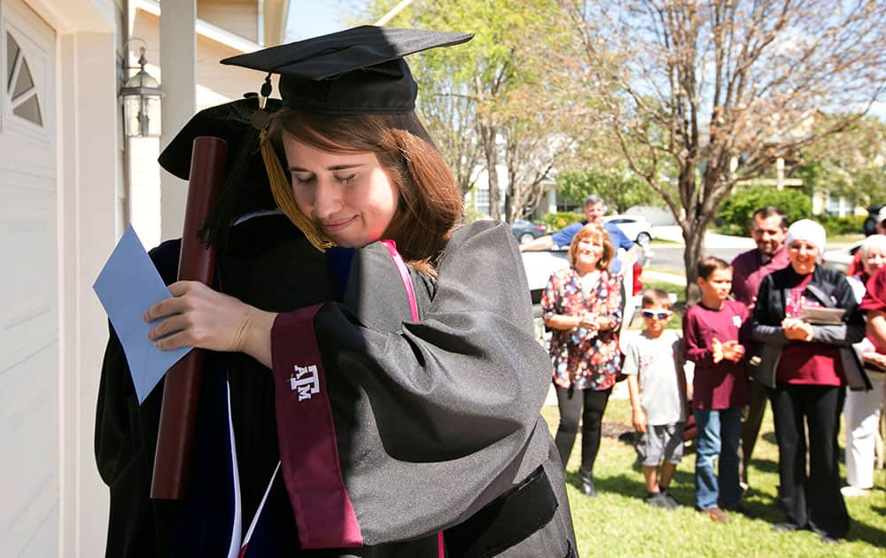 Jenny Brewer hugs John Hurtado, Texas A&M Associate Dean of Engineering Academic and Student Affairs, at her graduation ceremony at her home in Circle C Ranch  in Austin.