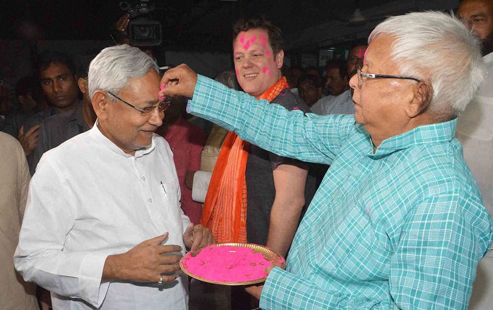 RJD Chief Lalu Prasad putting gulal to Bihar Chief Minister Nitish Kumar during Holi festival in Patna.