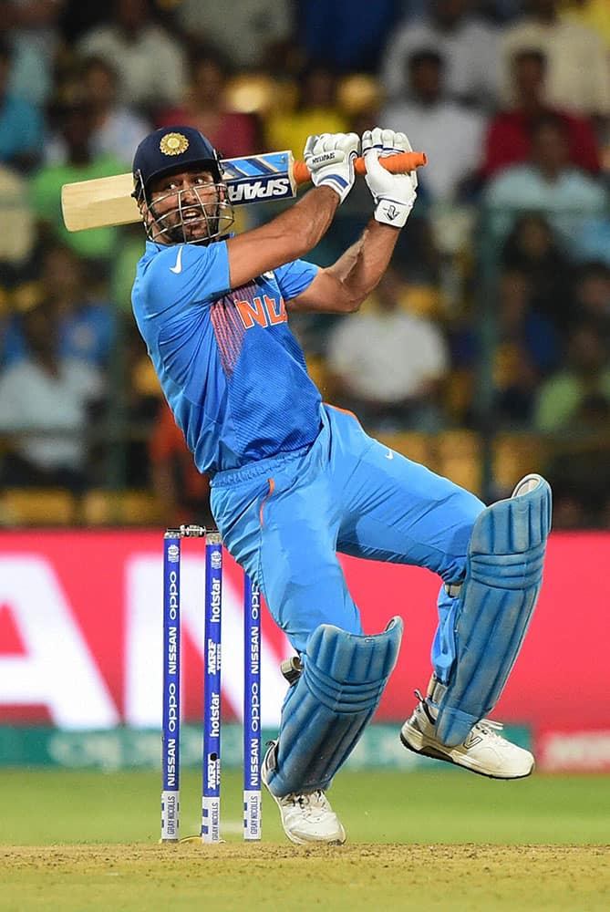 Indias M S Dhoni plays a shot during the ICC World T20 match between India and Bangladesh at Chinnaswamy Stadium in Bengaluru.