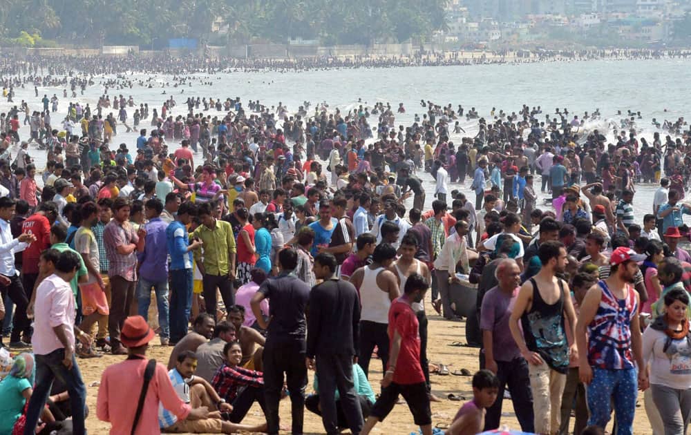 People celebrate Holi on a Juhu beach in Mumbai.