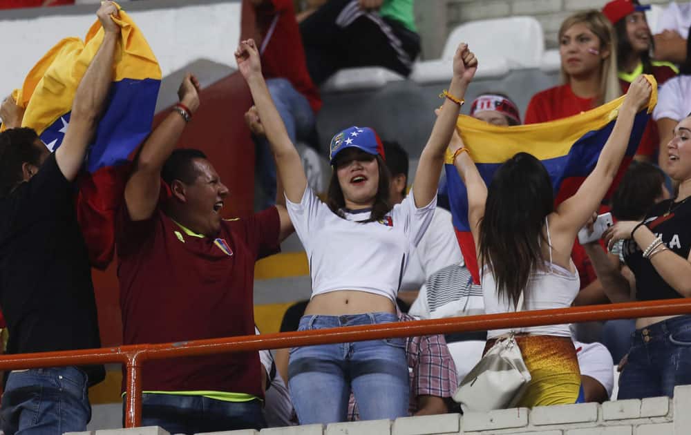 Venezuela soccer fans celebrate a goal against Peru at a 2018 World Cup qualifying match in Lima, Peru.