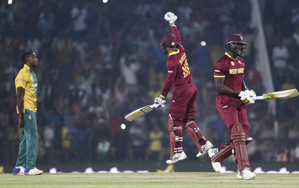 West Indies Denesh Ramdin, leaps in the air to celebrate after defeating South Africa in their ICC World Twenty20 2016 cricket match in Nagpur.