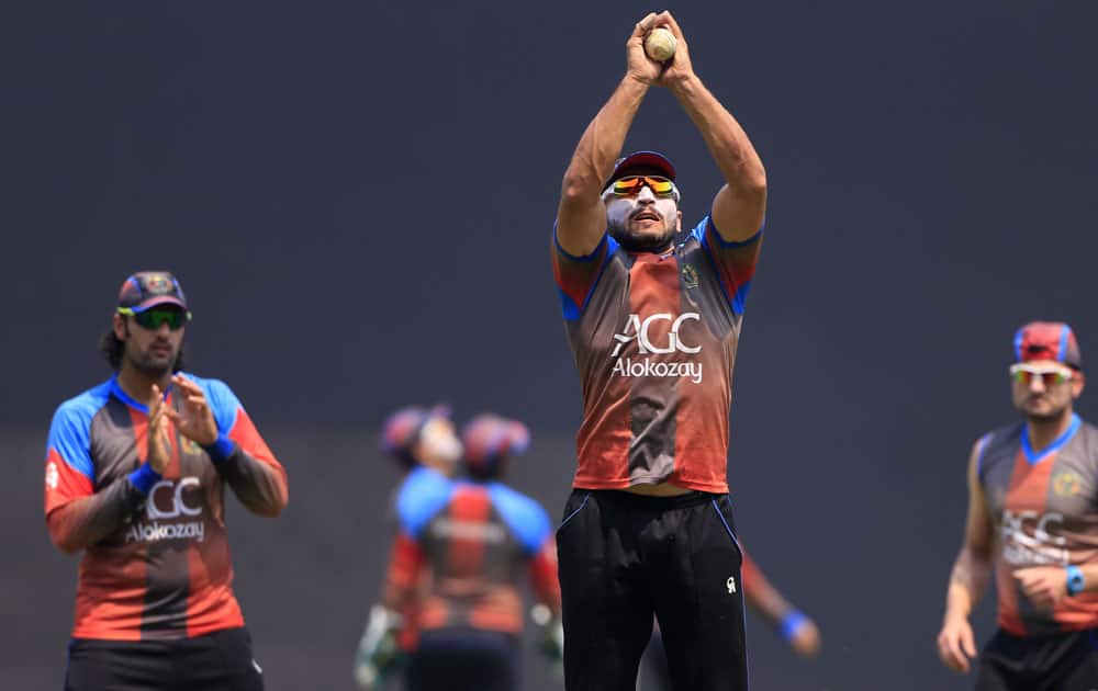 Afghanistan cricketer Gulbadin Naib, center, practices catching during a training session ahead of their ICC World Twenty20 2016 cricket match against West Indies, in Nagpur.