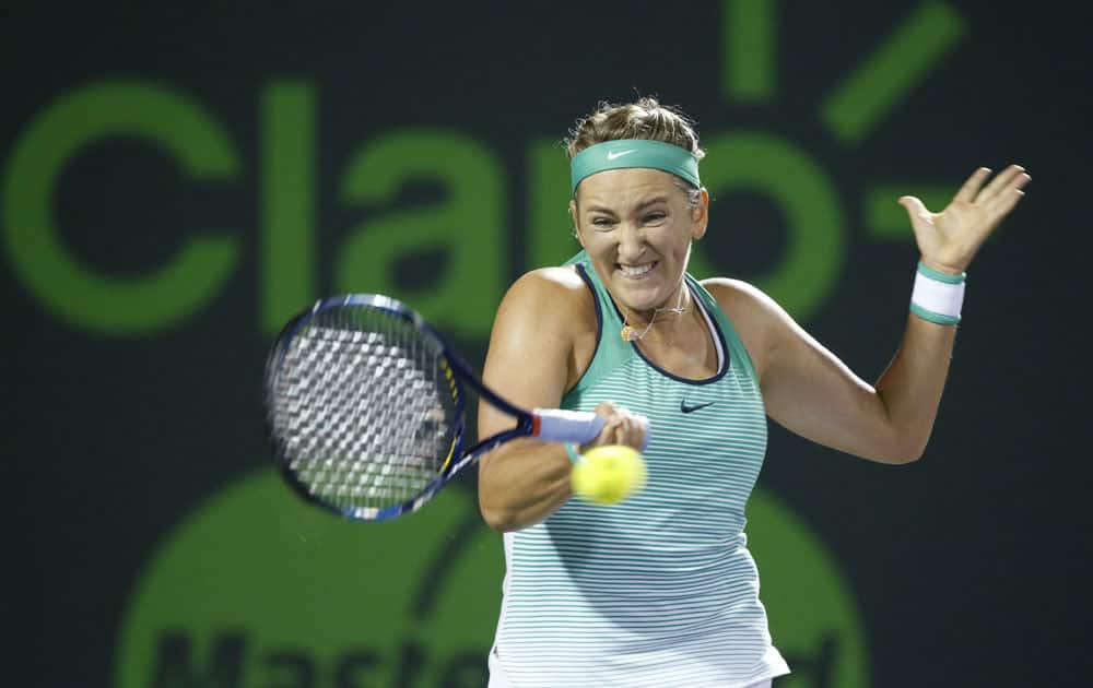 Victoria Azarenka, of Belarus, returns a shot from Monica Puig, of Puerto Rico, during a match at the Miami Open tennis tournament, in Key Biscayne, Fla.
