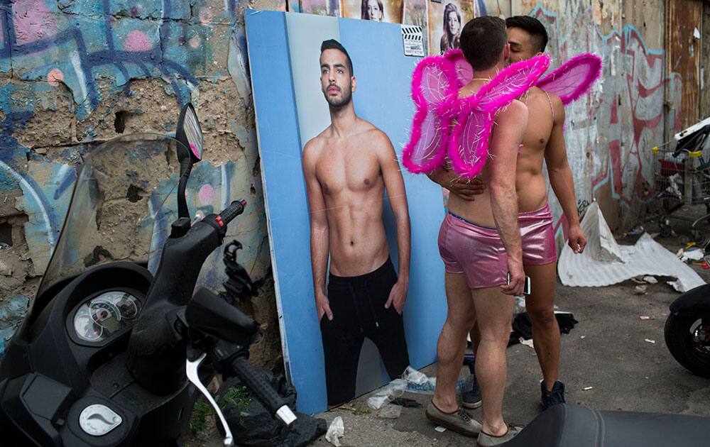 Two Israelis kiss as they wear costumes during a Purim party in Tel Aviv, Israel.