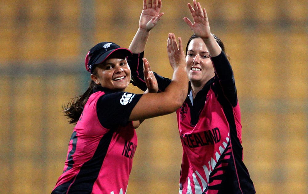 New Zealand's Erin Bermingham, right, celebrates with team captain Suzie Bates the dismissal of South Africa's Marizanne Kapp during their ICC Women's Twenty20 2016 Cricket World Cup match in Bangalore.