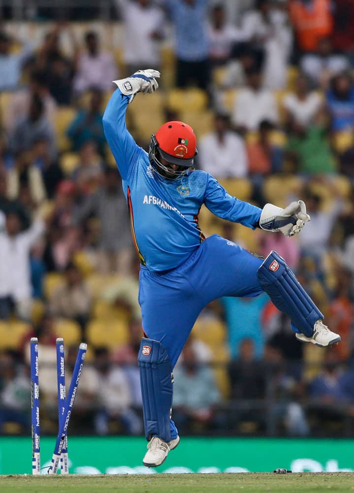 Afghanistan's wicketkeeper Mohammad Shahzad celebrates after stumping West Indies' batsman Denesh Ramdin during their ICC World Twenty20 2016 cricket match in Nagpur.