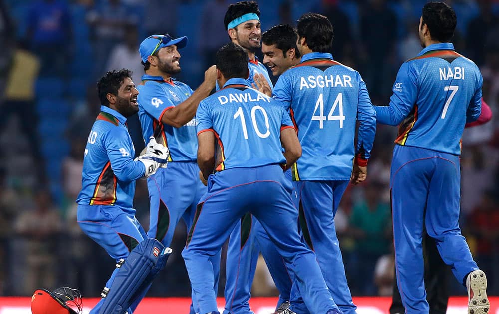 Afghanistan's cricketers celebrate their win over West Indies’ in the ICC World Twenty20 2016 cricket match in Nagpur.