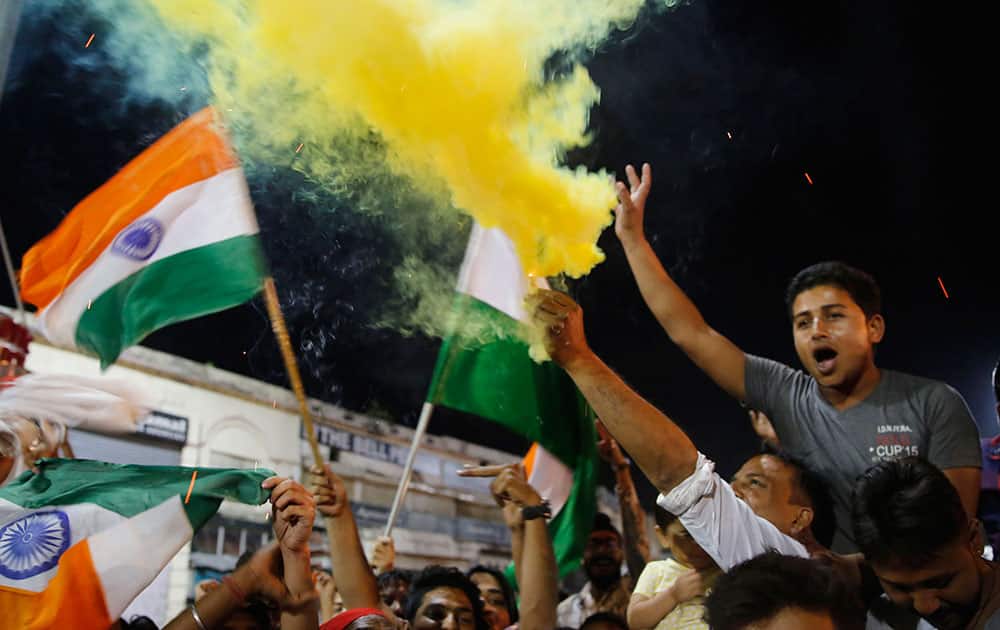Indian supporters celebrate their team's win over Australia in the ICC World Twenty20 2016 cricket match, in Lucknow.