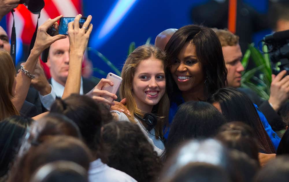 first lady Michelle Obama has her picture taken with high school students at the Metropolitan Center of Design in Buenos Aires, Argentina.
