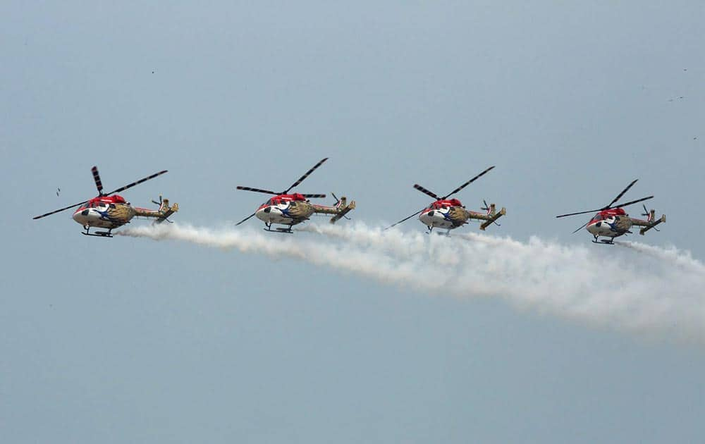 Sarang helicopters maneuvering their skill at the inauguration of 9th edition of Defexpo-16 in Panaji, Goa.