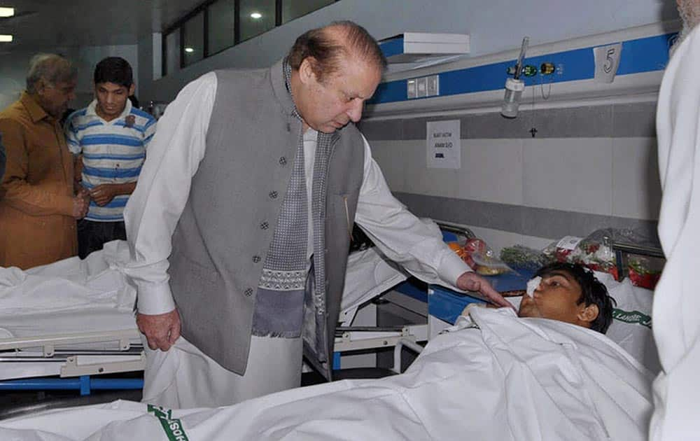 Pakistans Prime Minister Nawaz Sharif talks to an injured victim of Sundays suicide bombing during his visit to a local hospital in Lahore, Pakistan.