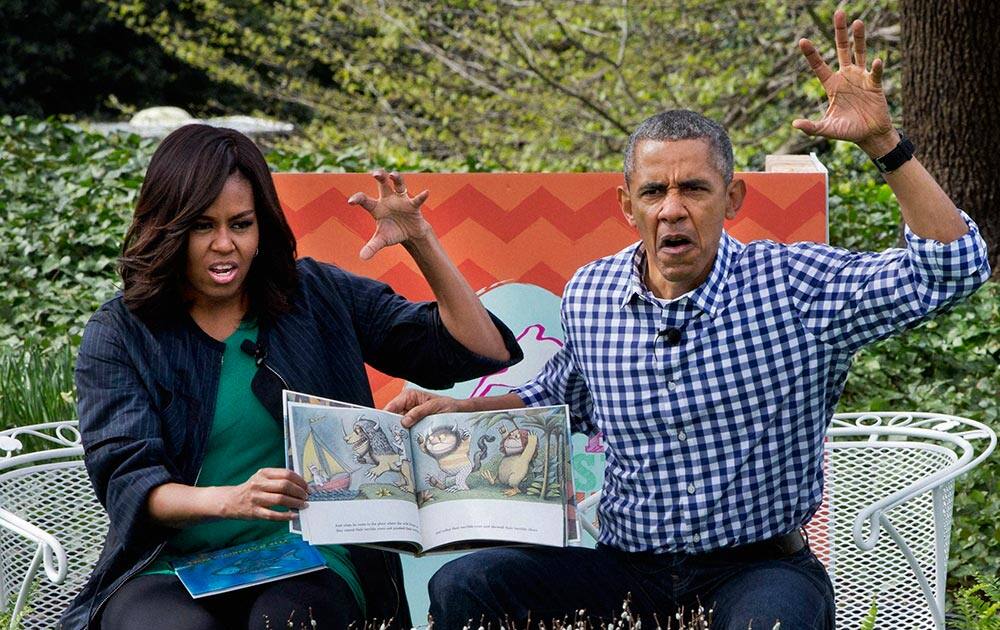 President Barack Obama and first lady Michelle Obama make claw hands and monster faces while reading, Where The Wild Things Are, during White House Easter Egg Roll at the White House in Washington.