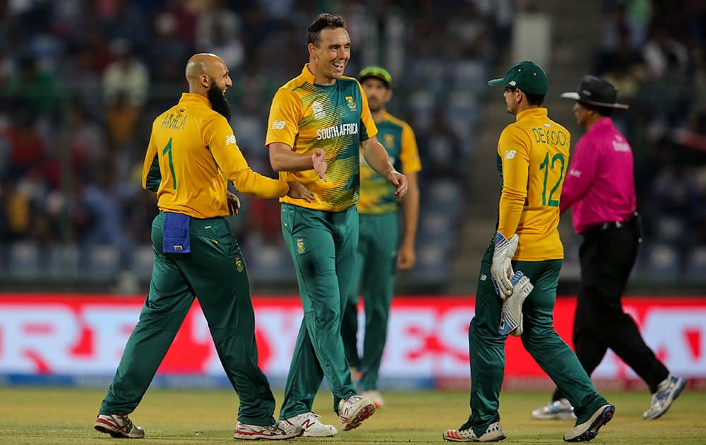 South Africa's Kyle Abbott, center, celebrates the wicket of Sri Lanka's Rangana Herath during their ICC Twenty20 2016 Cricket World Cup match at the Feroz Shah Kotla Cricket Stadium in New Delhi.