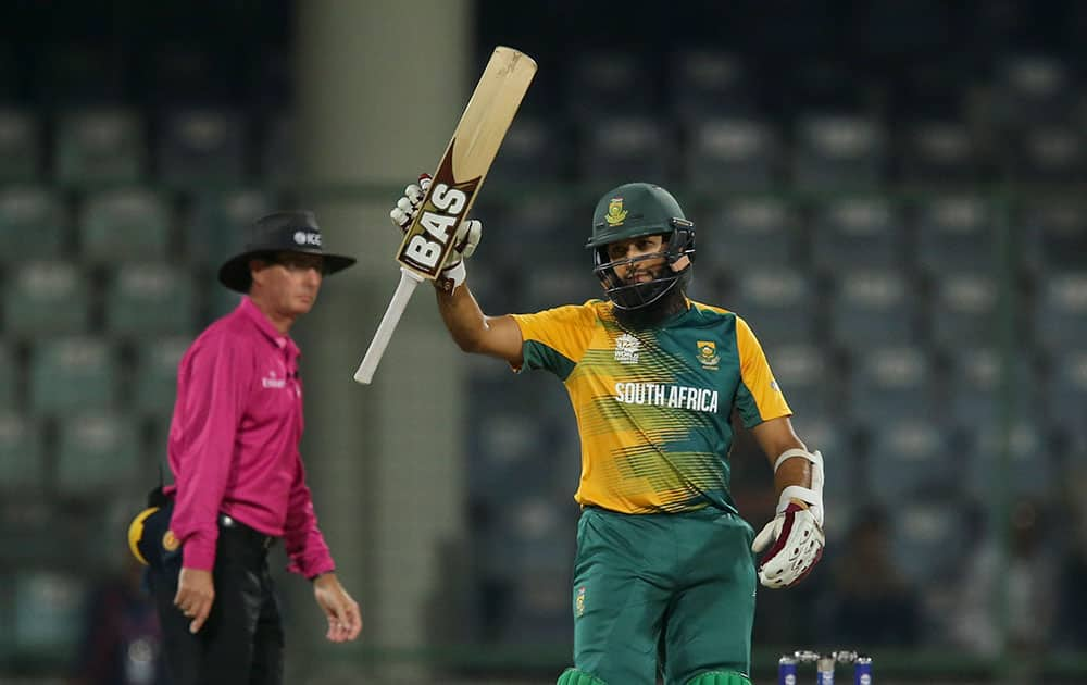 South Africa's Hashim Amla acknowledges his fifty runs against Sri Lanka during their ICC Twenty20 2016 Cricket World Cup match at the Feroz Shah Kotla Cricket Stadium in New Delhi.