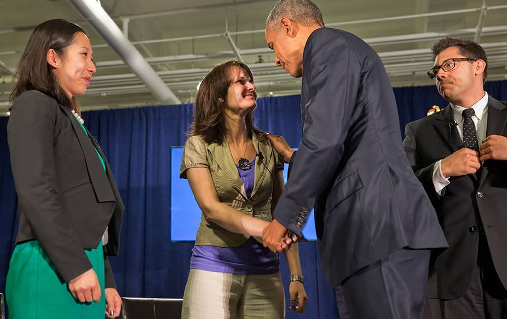 President Barack Obama thanks Crystal Oertle of Shelby, Ohio, for sharing her story of recovery from addiction after they spoke on a panel with Baltimore City Health Commissioner Dr. Leana Wen, left, and Young People in Recovery President and CEO Justin Riley, during the National Rx Drug Abuse & Heroin Summit at AmericasMart in Atlanta.