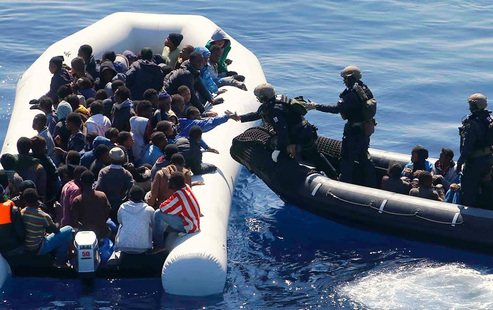 German Navy sailors surround a boat with more than 100 migrants near the German combat supply ship Frankfurt am Main during EUNAVFOR Med, also known as Operation Sophia, in the Mediterranean Sea off the coast of Libya.