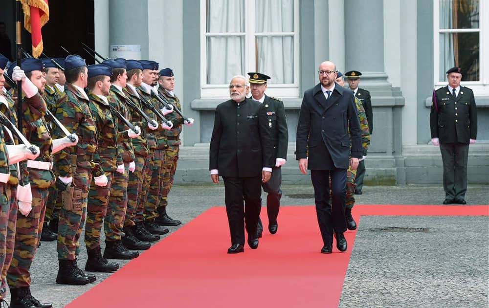 Prime Minister Narendra Modi reviews a guard of honor along with his Belgian counterpart Charles Michael at a ceremonial welcome at the Egmont Palace in Brussels.