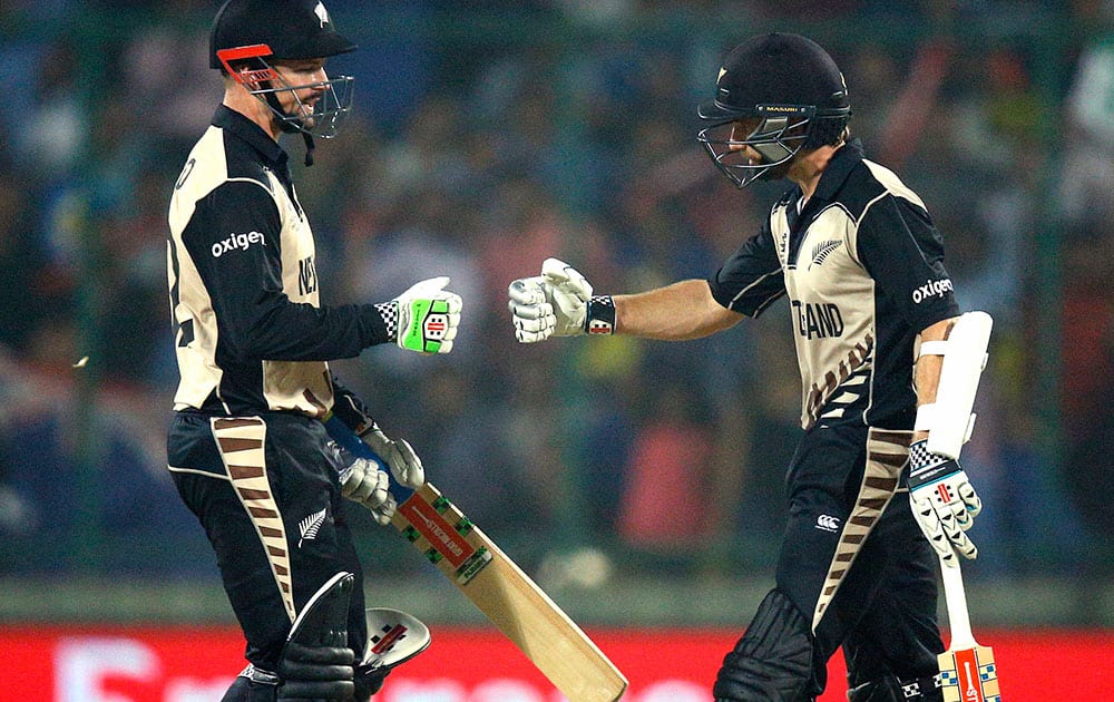 New Zealand's Colin Munro, left, and Kane Williamson celebrate while batting against England during their ICC World Twenty20 Cricket World Cup semifinal match at the Feroz Shah Kotla cricket stadium in New Delhi.