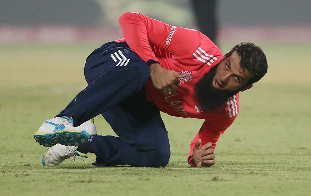 England's Moeen Ali takes a catch during their ICC Twenty20 2016 Cricket World Cup semifinal match against New Zealand at the Feroz Shah Kotla Cricket Stadium in New Delhi.