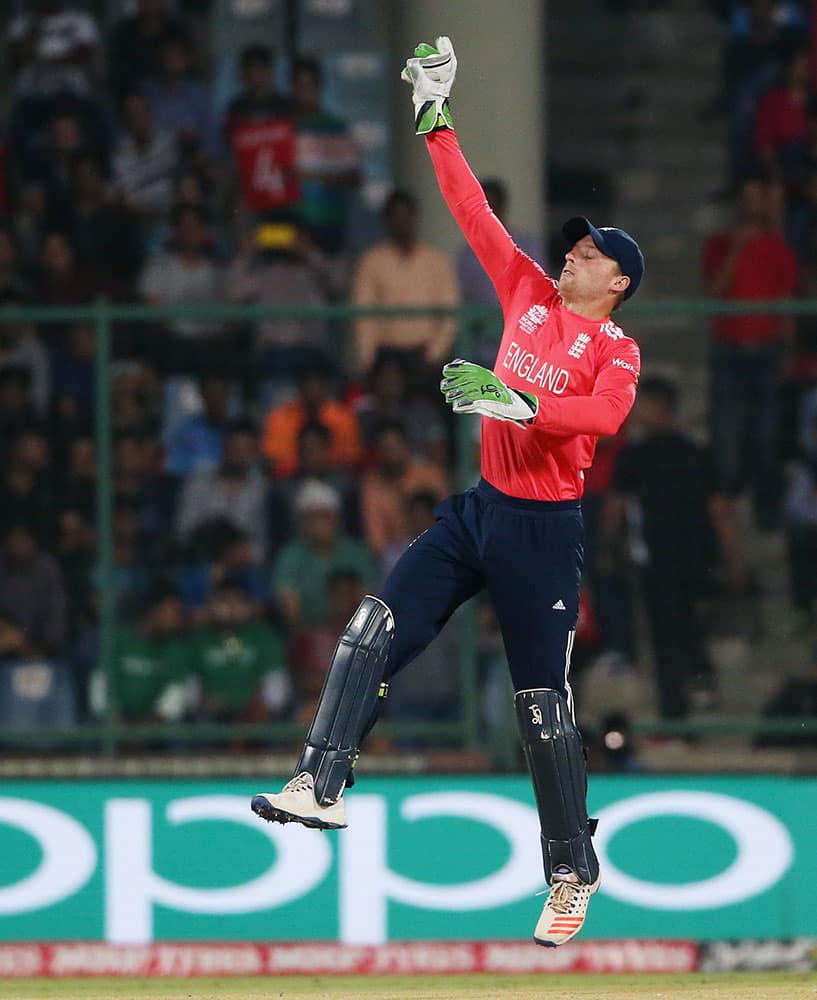 England's Jos Buttler leaps to take the ball during their ICC Twenty20 2016 Cricket World Cup semifinal match against New Zealand at the Feroz Shah Kotla Cricket Stadium in New Delhi.