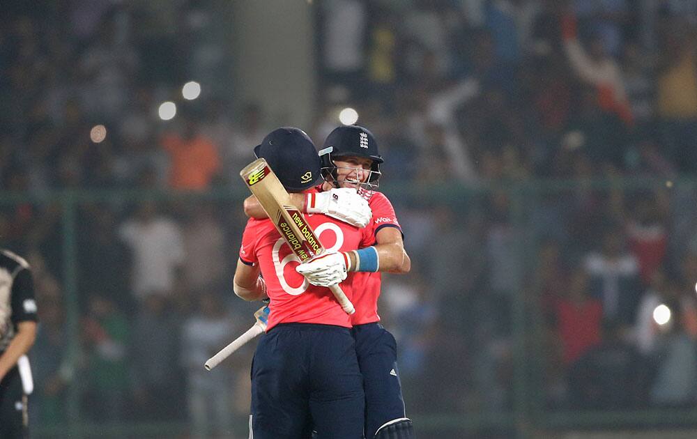 England's Joe Root, facing camera, hugs teammate Jos Buttler after defeating New Zealand during their ICC Twenty20 2016 Cricket World Cup semifinal match at the Feroz Shah Kotla Cricket Stadium in New Delhi.