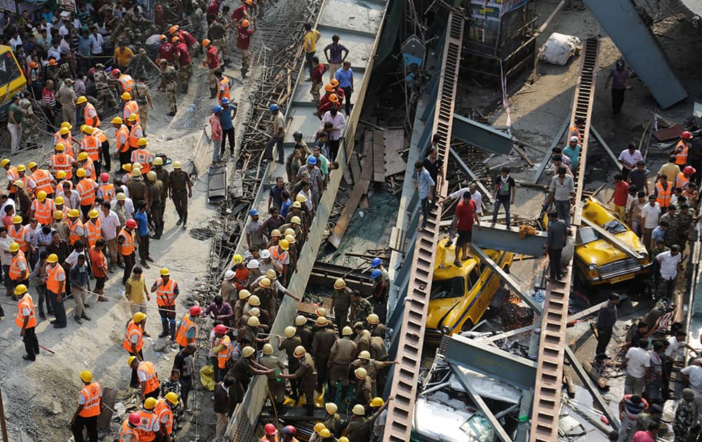 Rescue workers clear the rubbles of a partially collapsed overpass in Kolkata.