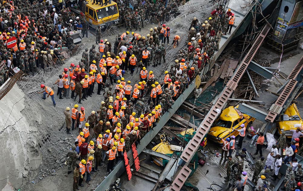 Soldiers and rescue workers work on a partially collapsed overpass in Kolkata.