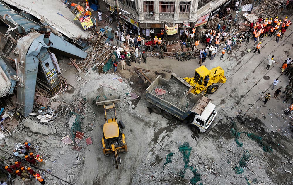 Excavator machines remove debris of a partially collapsed overpass in Kolkata.