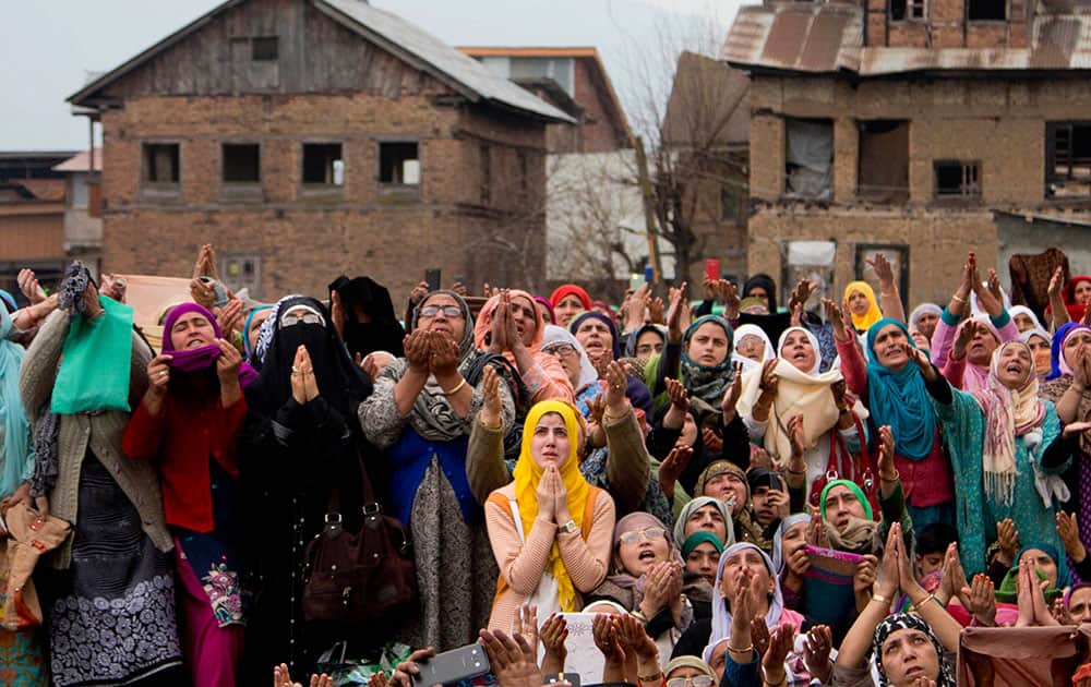 Kashmiri Muslim women devotees pray as a head priest displays a relic, believed to be a hair from the beard of the Prophet Mohammad, during special prayers on the death anniversary of Abu Bakr Siddiq, the first Caliph of Islam, at Hazratbal Shrine on the outskirts of Srinagar.