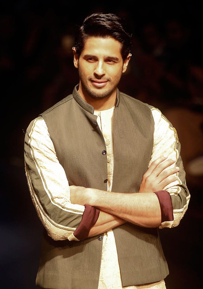 Bollywood actor Sidharth Malhotra displays a creation by Kunal Rawal during the Lakme Fashion Week in Mumbai.