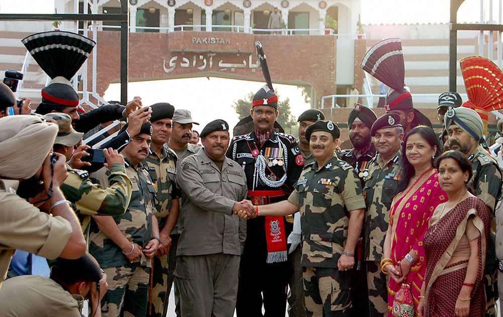 BSF DG KK Sharma giving fruits basket to his counterparts of Pakistan Rangers from Attari international border during his visit on Saturday.