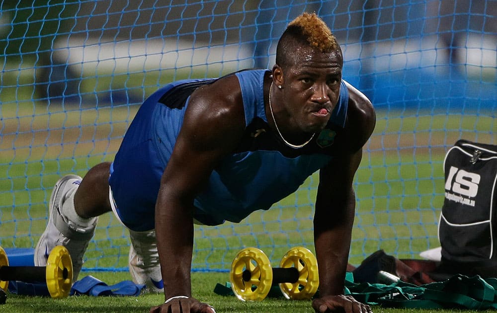 West Indies’ Andre Russell does push ups during a practice session a day ahead of their final match of the ICC World Twenty20 2016 cricket against England, in Kolkata.