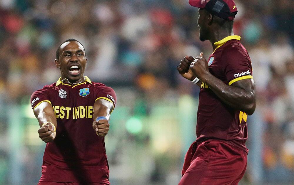 West Indies’ Dwayne Bravo and captain Darren Sammy celebrate England's Moeen Ali's wicket during the final of the ICC World Twenty20 2016 cricket tournament at Eden Gardens in Kolkata.