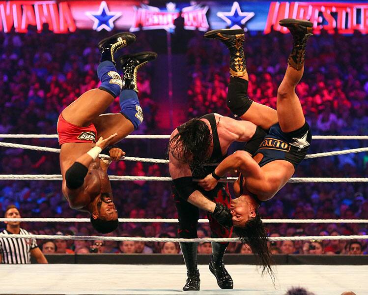 Two wrestlers are thrown from the ring during the Andre the Giant Memorial Battle Royal at Wrestlemania 32 at AT&T Stadium in Arlington, Texas.