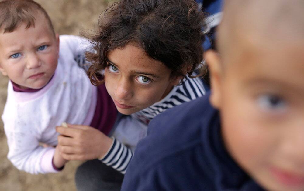 Migrant children near the makeshift camp at the northern Greek border point of Idomeni, Greece.