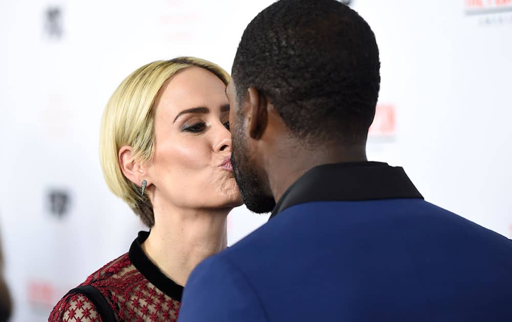 Sarah Paulson kisses Sterling K. Brown as they arrive at the 
