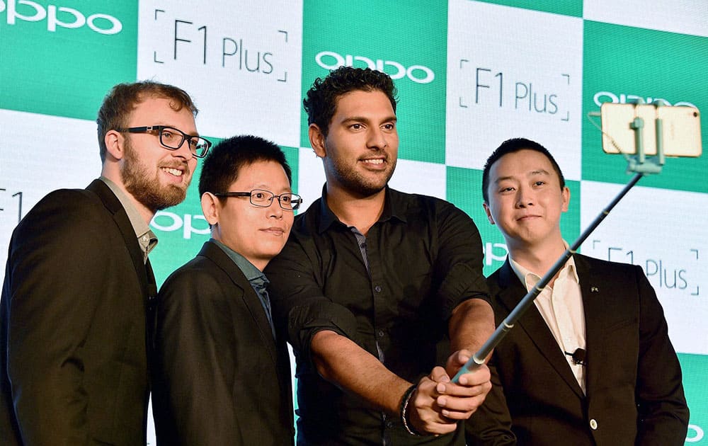 Indian cricketer Yuvraj Singh taking selfie with Mike Wang, CEO, OPPO Mobiles India; Marton Barcza, Product Expert, OPPO Mobiles and Will Yang, Brand Director, OPPO Mobiles, during the launch of OPPOs new Selfie Expert F1 Plus in New Delhi.