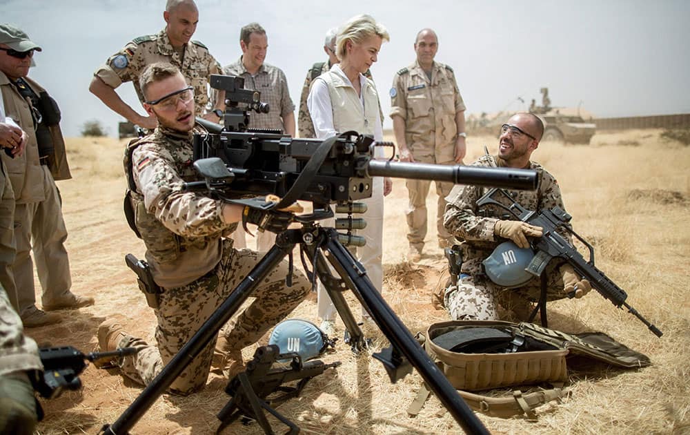 German defense minister Ursula von der Leyen , center speaks with German soldiers at Camp Castor near Gao, Mali.