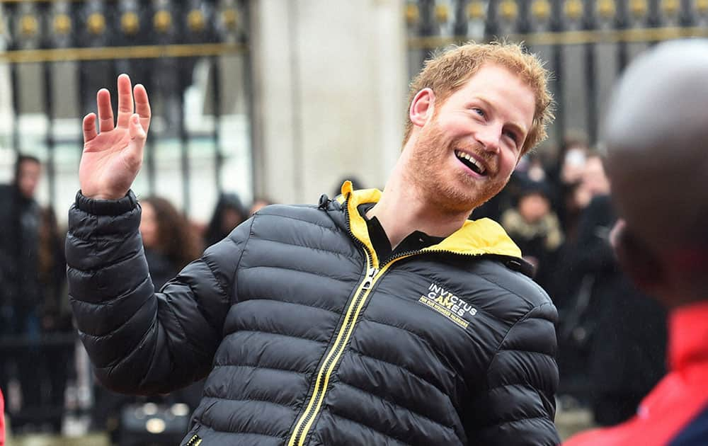 Britains Prince Harry, 2nd left, talks to members of the UK team for the upcoming Invictus Games 2016, at Buckingham Palace in London.
