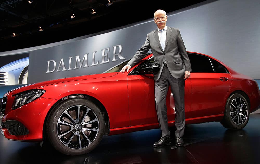 Dieter Zetsche, CEO of the Daimler AG, poses next to a car prior to the shareholders meeting of the carmaker in Berlin, Germany.